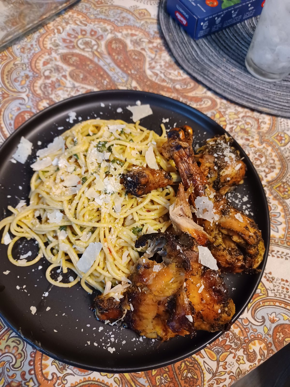Pesto spaghetti with roasted wings and shaved parmesan